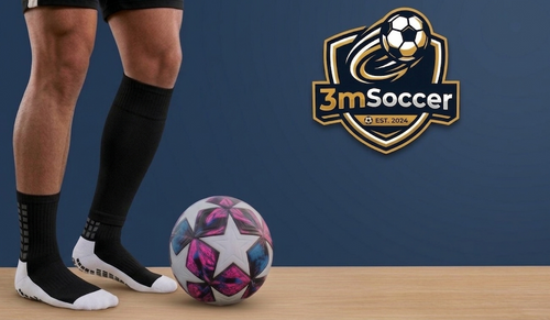 Person wearing soccer cleats with a colorful soccer ball on a wooden surface, featuring the 3mSoccer logo.
